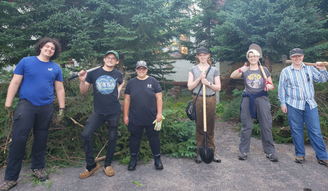 picture of several individuals posing with gardening equipment