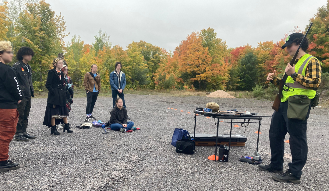 picture of several individuals standing for an outdoor firearms safety class